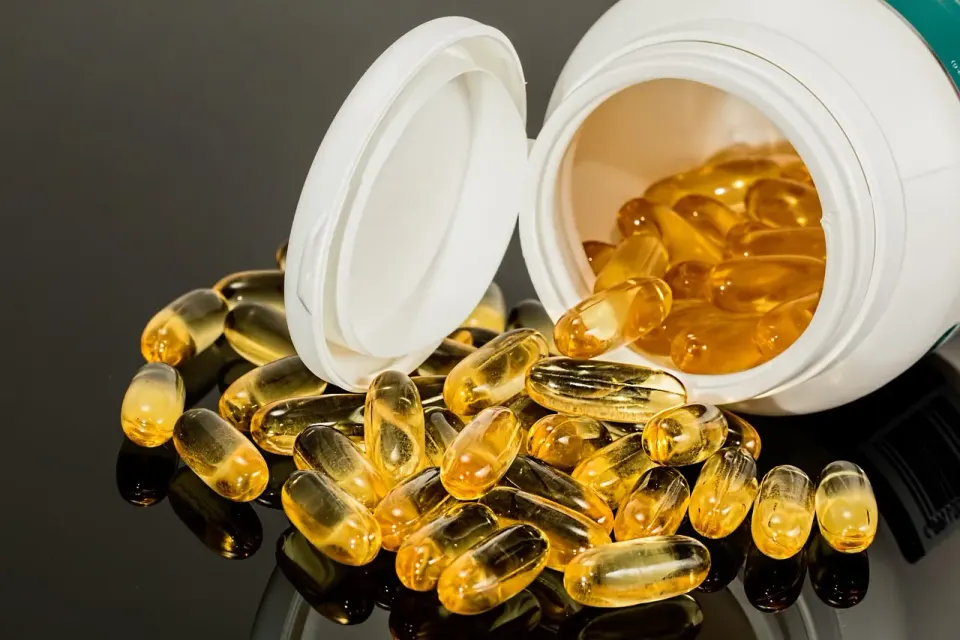 Loose pills and capsules spilled from a medicine bottle