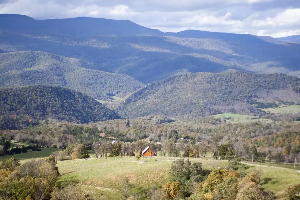 A house among fall trees on a hillside in West Virginia
