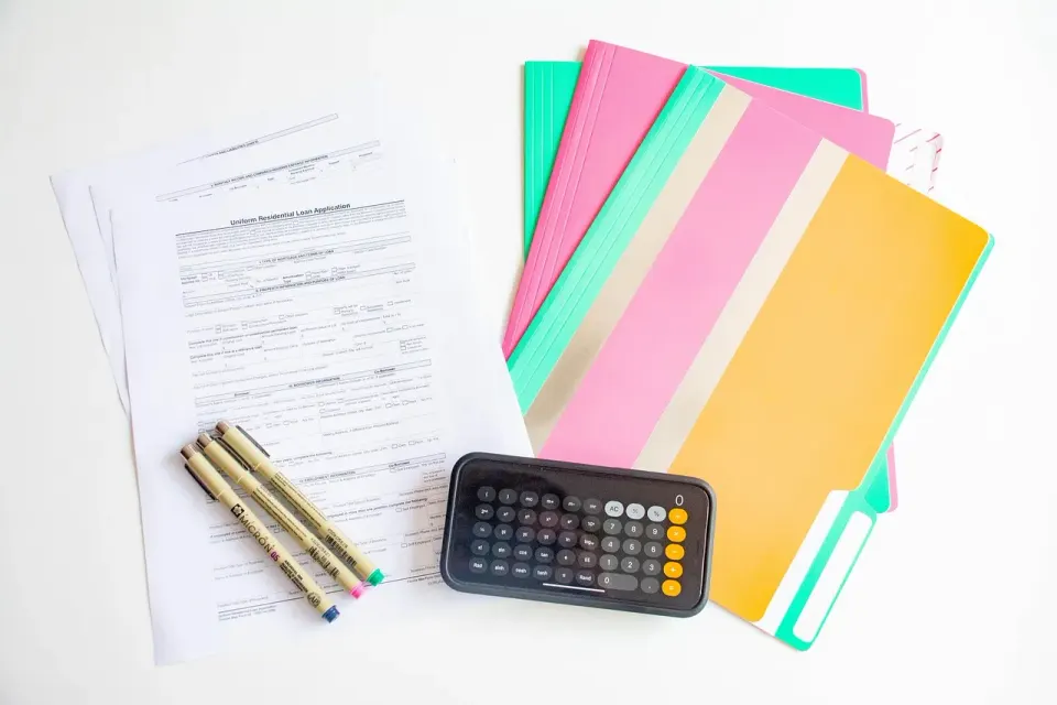 Calculator and notepad on a desk for working through home sale numbers